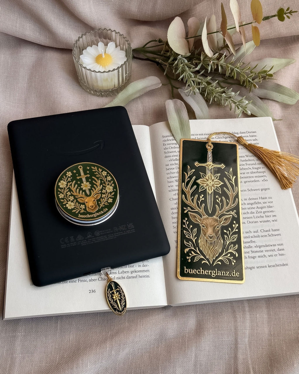 Heir of the Forest reading set: grip on an e-reader, The Verdant Vow bookmark and Blade & Bloom charm plug on a book