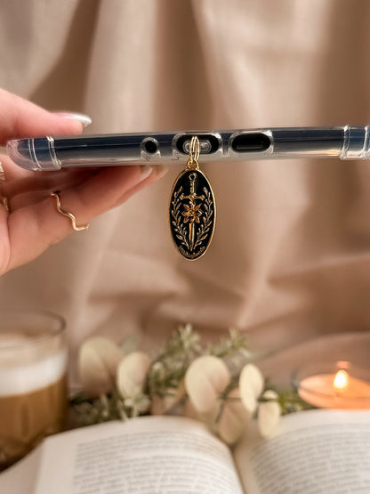 Blade & Bloom – USB-C Dustplug – Lifestyle hängend am Kindle Hand Kerze weiße Blumen, buecherglanz